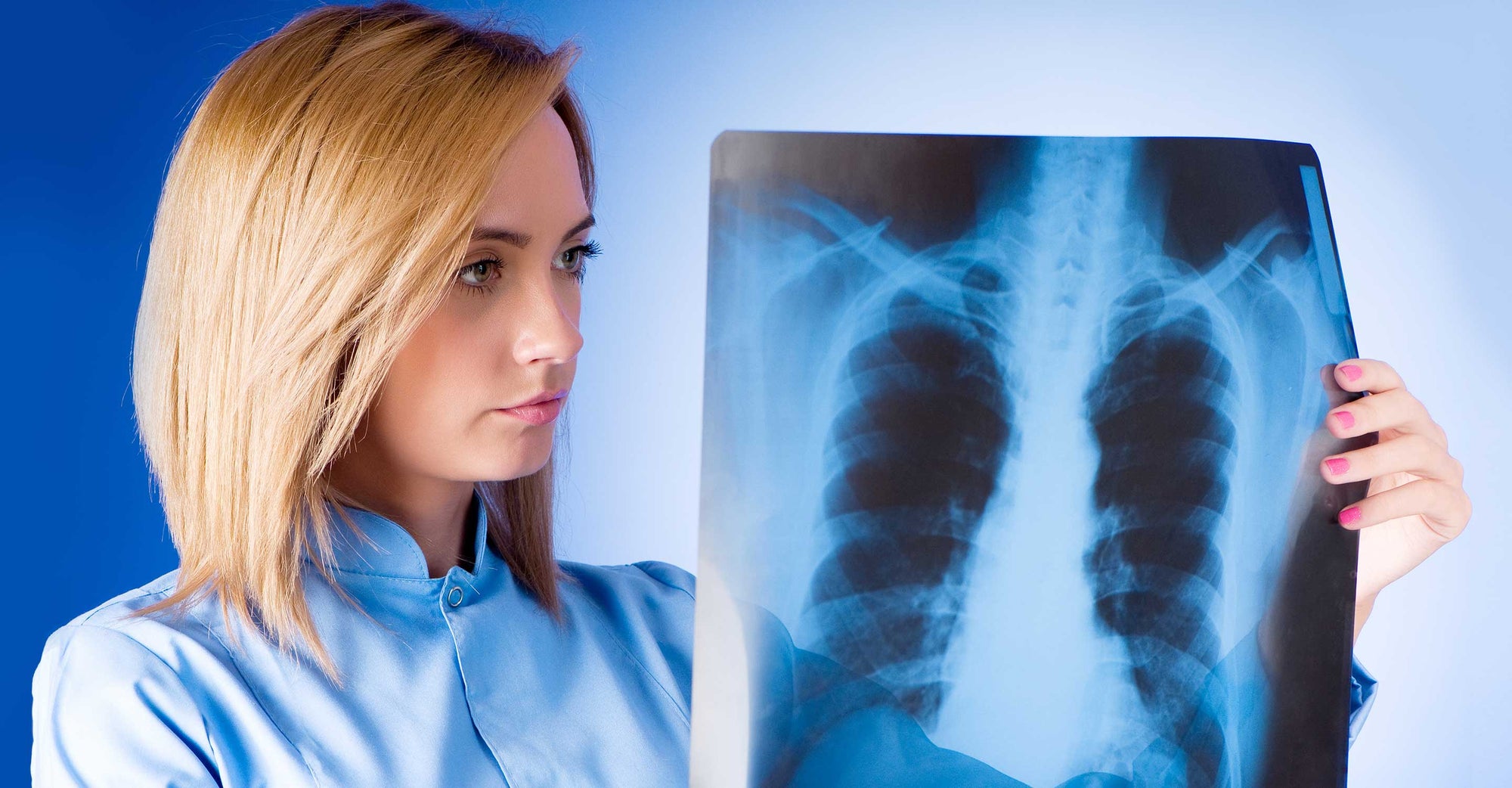 woman looking at x-ray image of chest