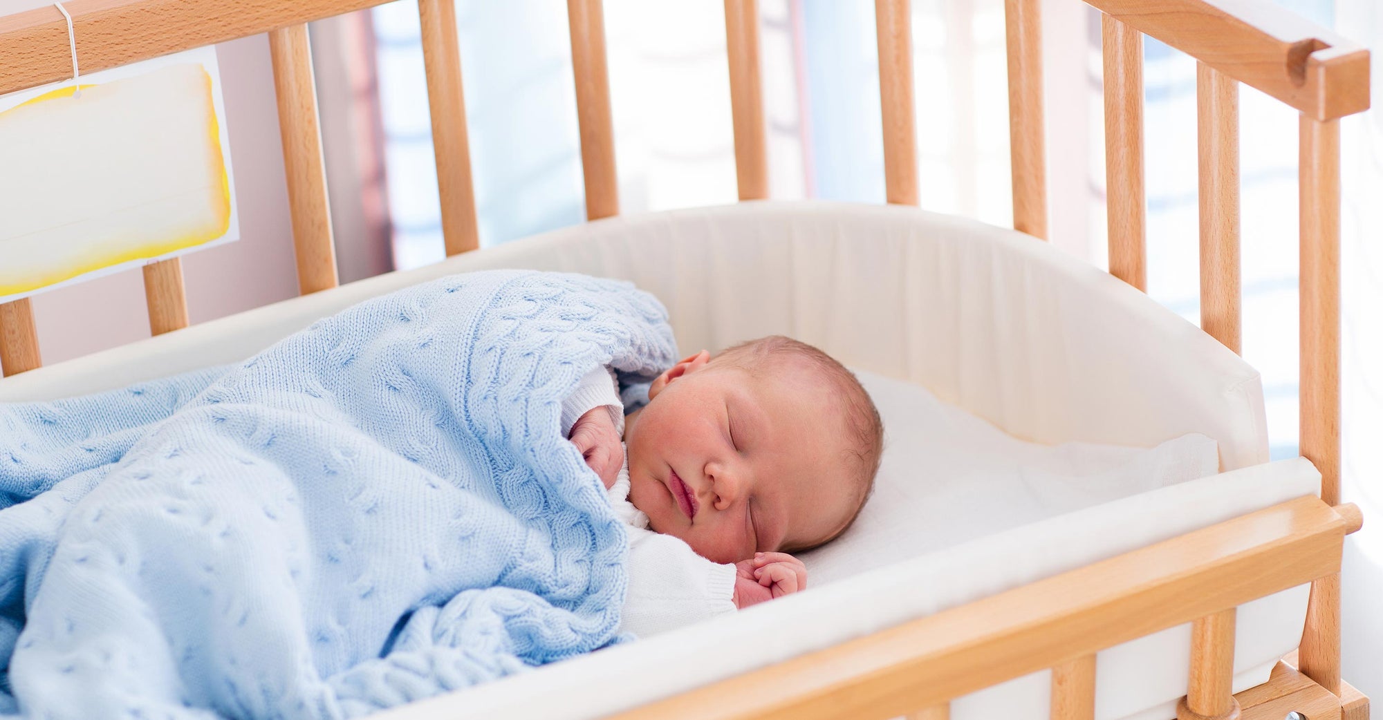 A baby sleeping in a crib.