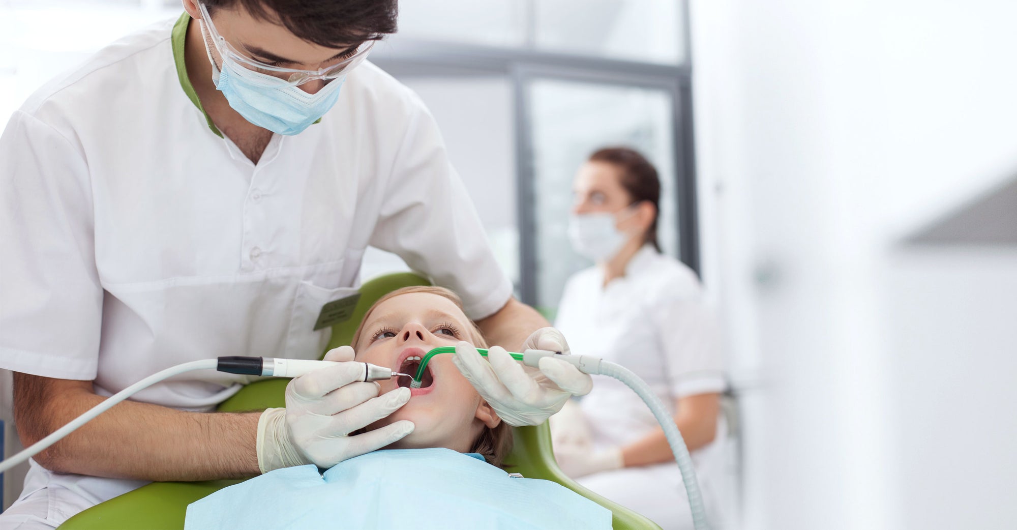 Image of dental professional and child in dental office