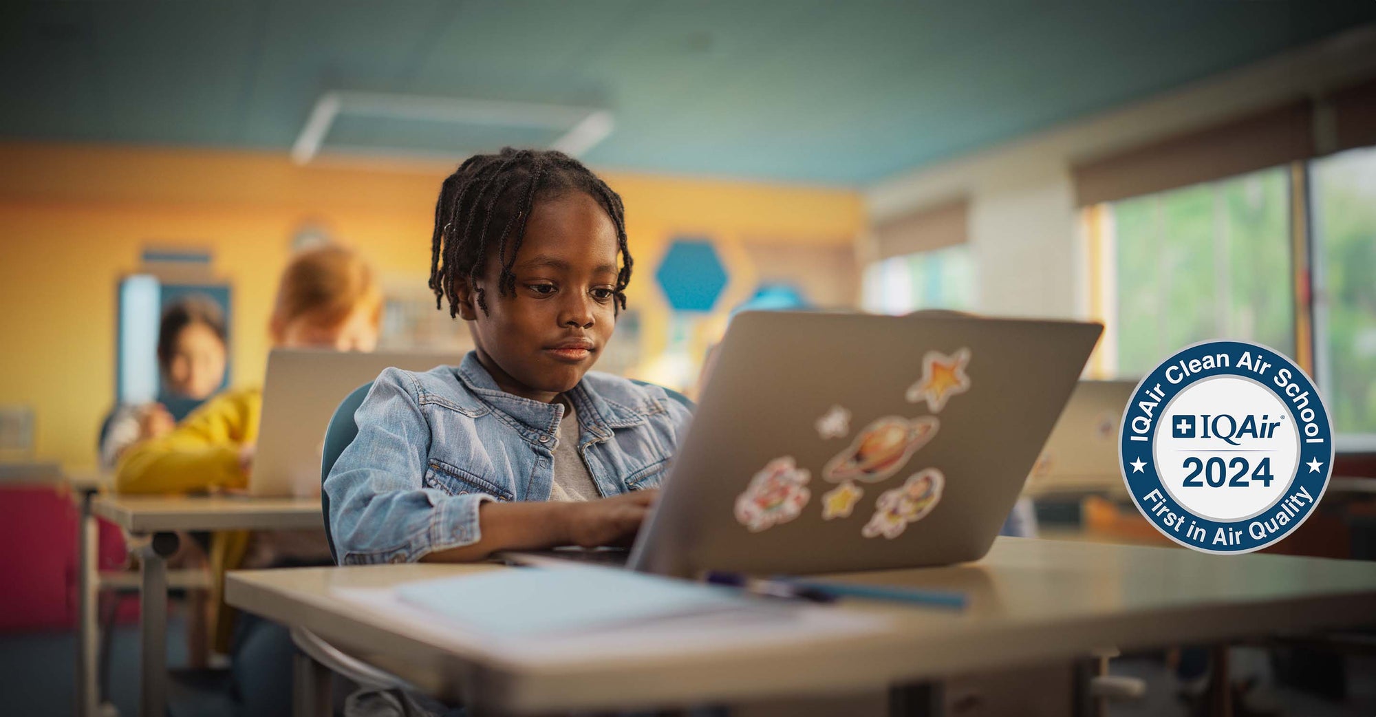 Child sitting at desk in a clean air school