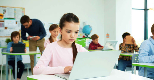 girl in class with laptop