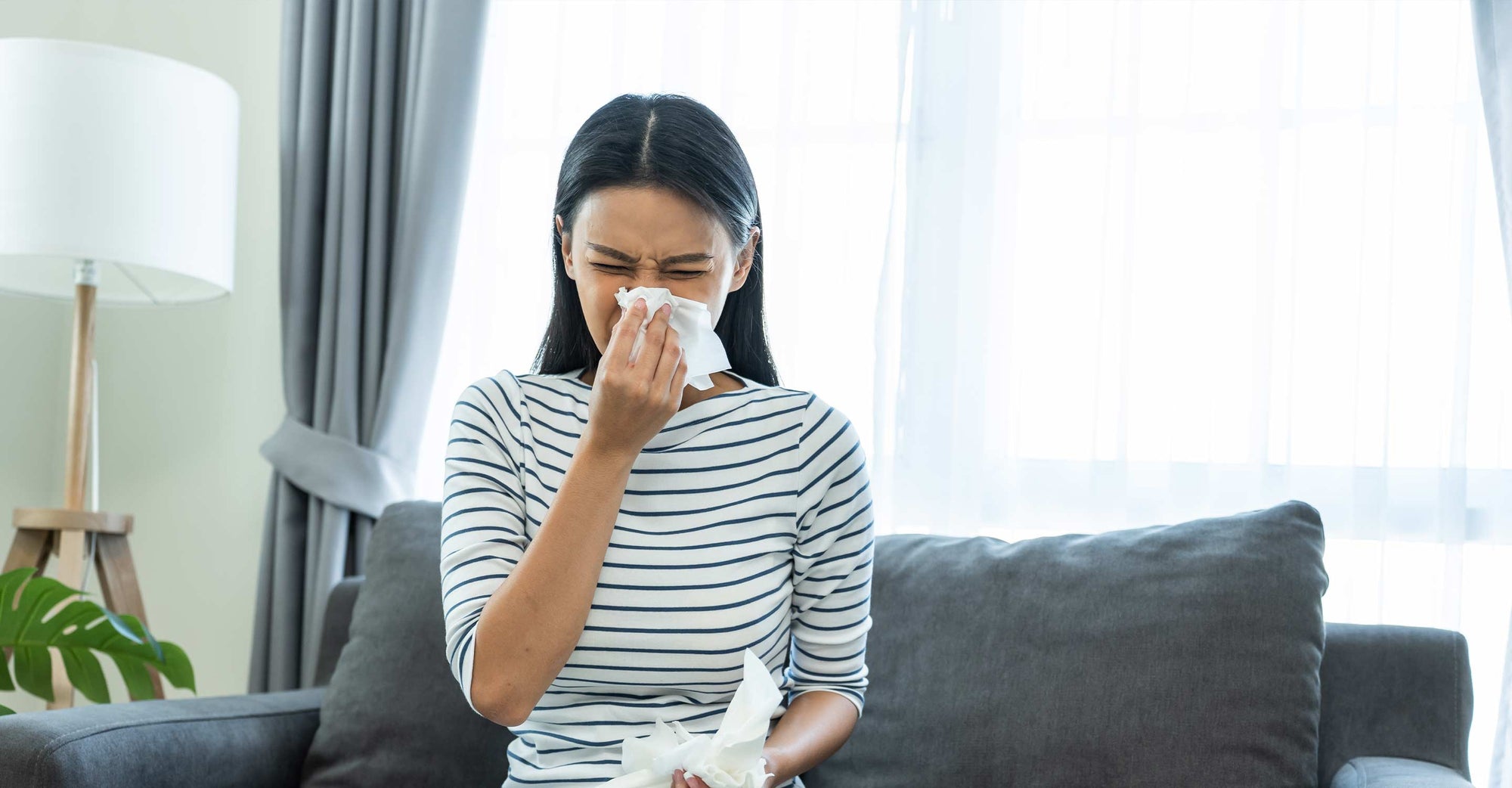 women sneezing needs best air purifier for allergies