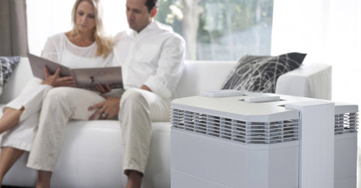 Couple sitting on couch enjoying the IQAir HealthPro