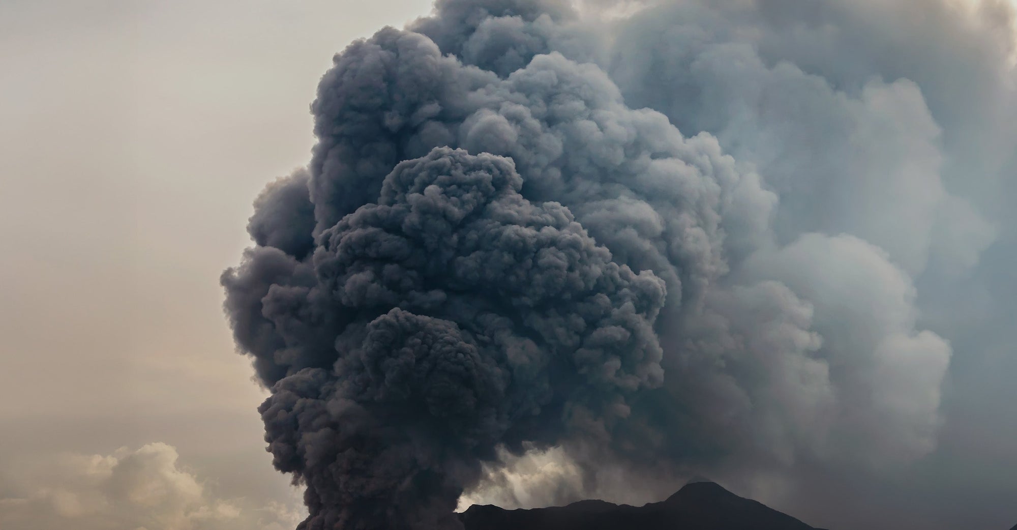 Plume of ash rising from volcano
