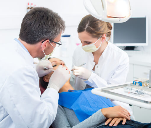 Dentists operating on woman