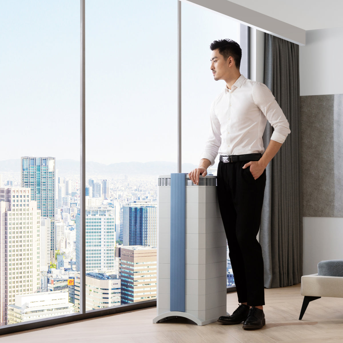 Man resting hand on top of GCX Series air purifier