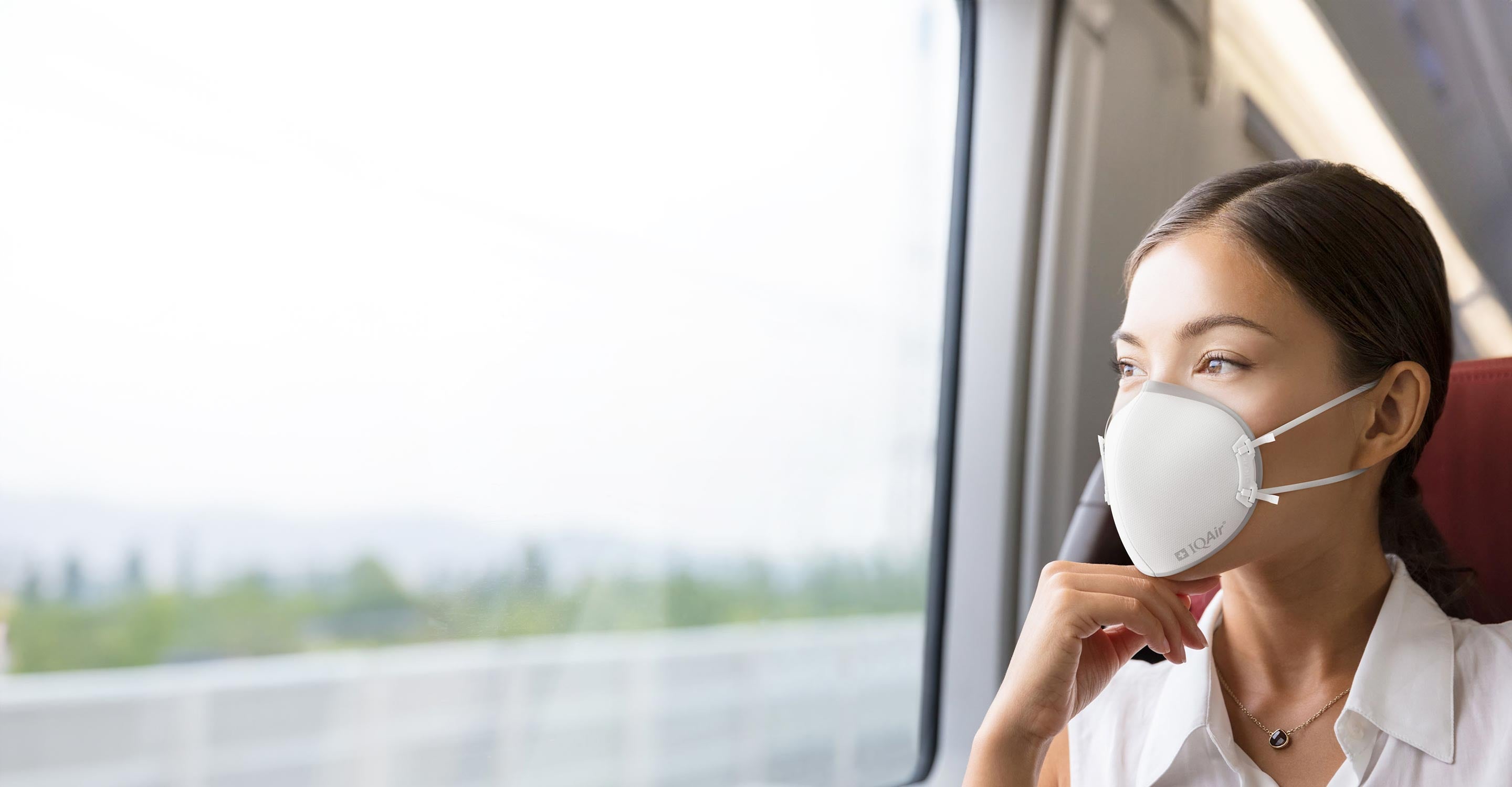 Woman wearing IQAir Mask on train
