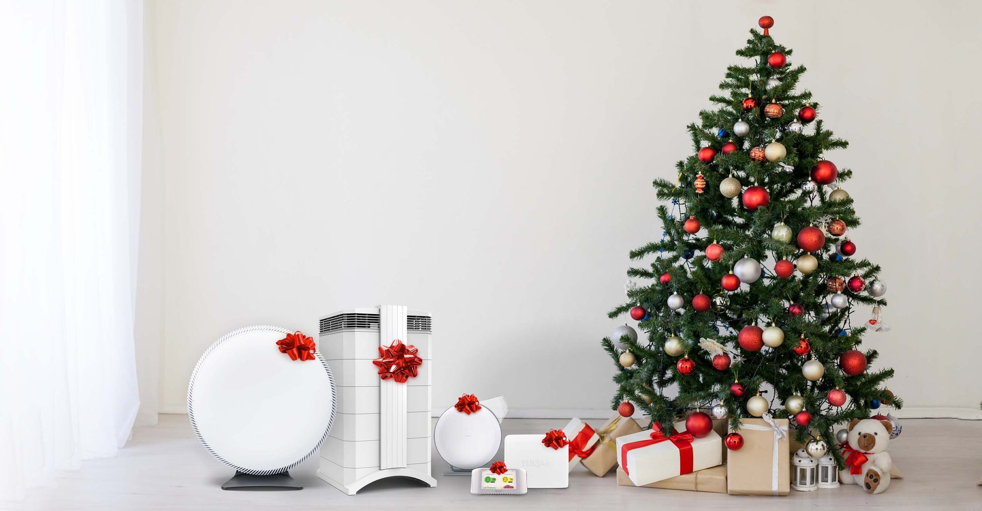 Air purifiers with bows next to Christmas tree