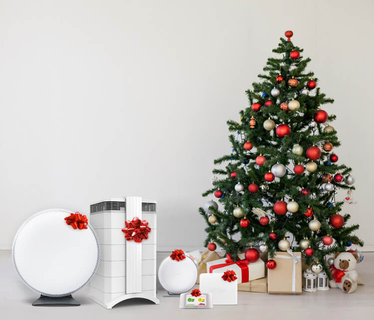 Air purifiers with bows next to Christmas tree