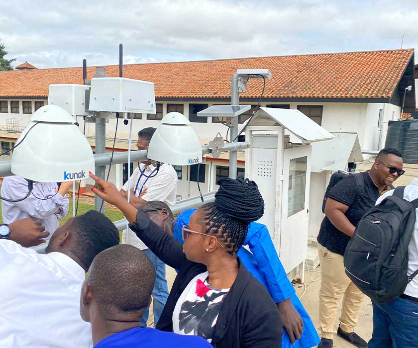 Group inspecting outdoor air quality monitors