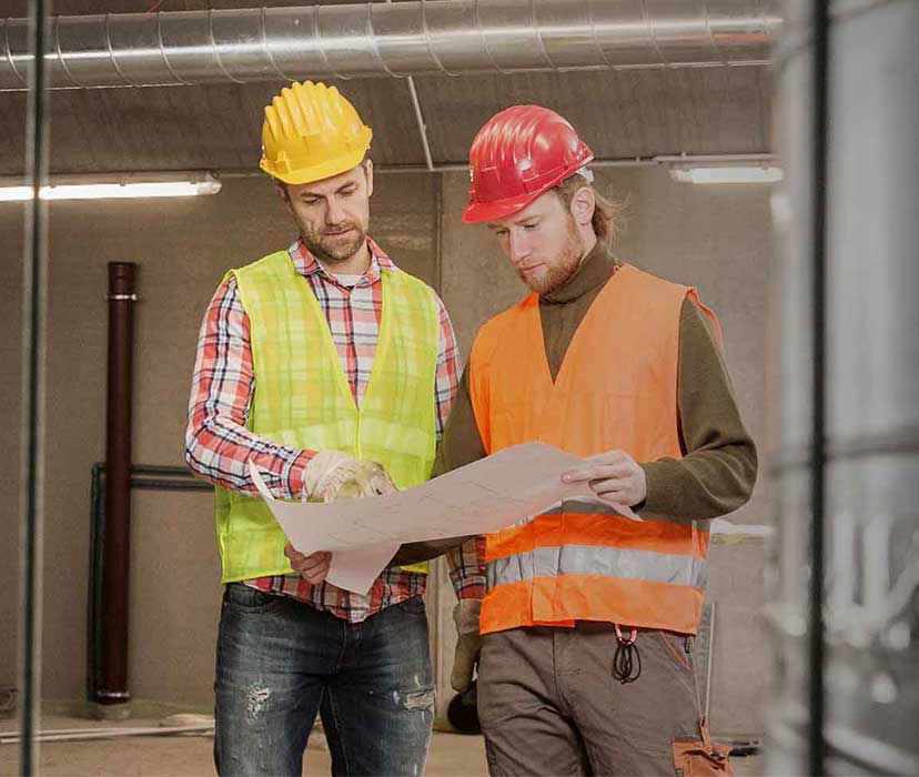 construction workers holding plans