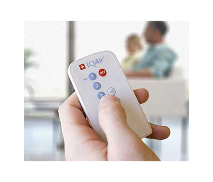 person pressing IQAir remote buttons